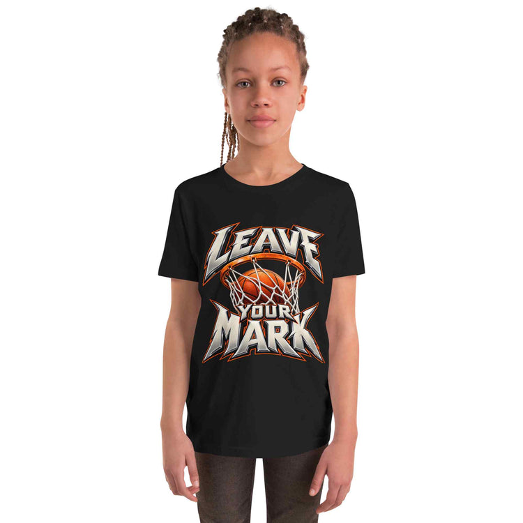 A child model wearing a black short-sleeve t-shirt with a graphic print that reads 'LEAVE YOUR MARK' around a basketball and hoop, set against a plain white background.
