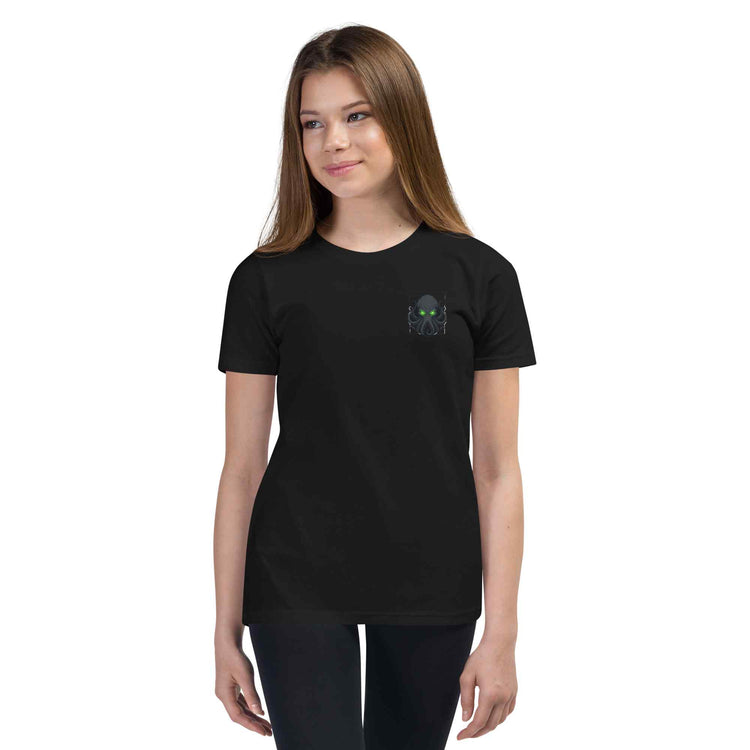 Person wearing a black t-shirt with 'kraken text  consume your demons on a white background 