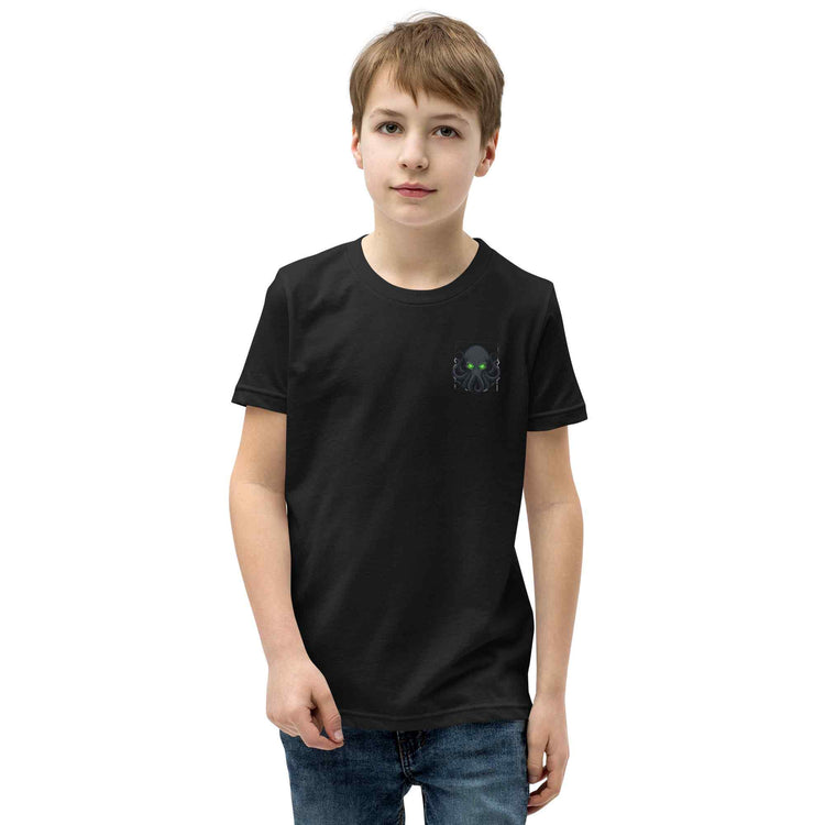 Young person wearing a black t-shirt with a Kraken logo on a white background