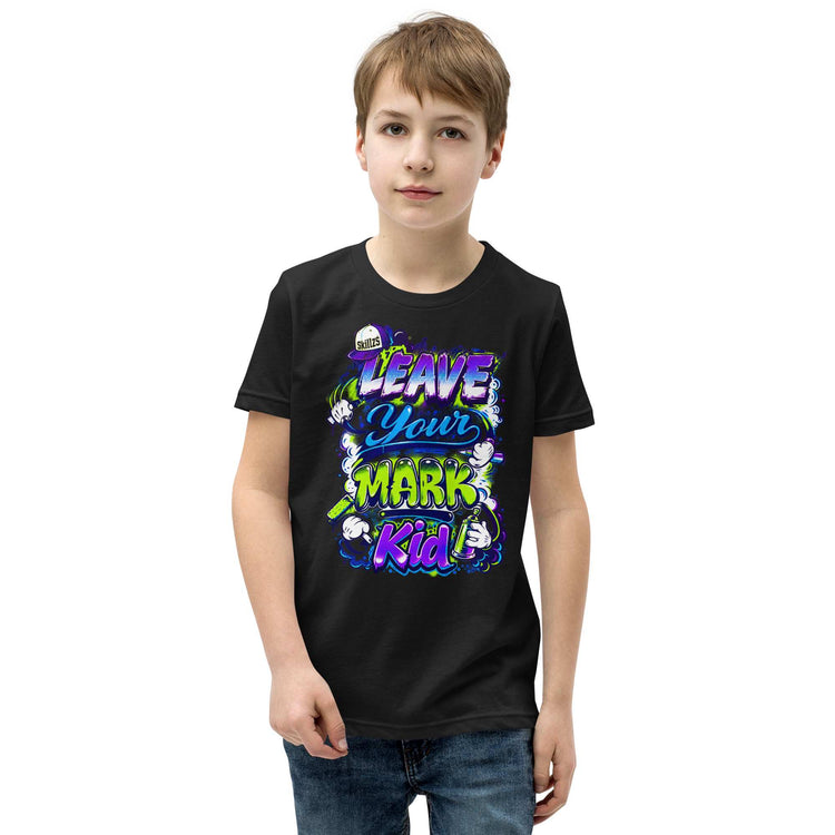 A young boy wearing a black graphic t-shirt with a colorful 'Leave Your Mark Kid' design, paired with blue jeans, set against a plain white background.