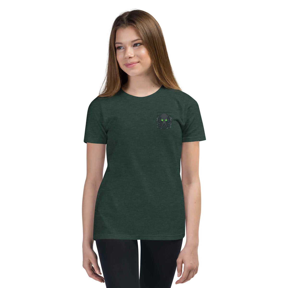 Person wearing a dark green t-shirt with a small  kraken logo on a white background