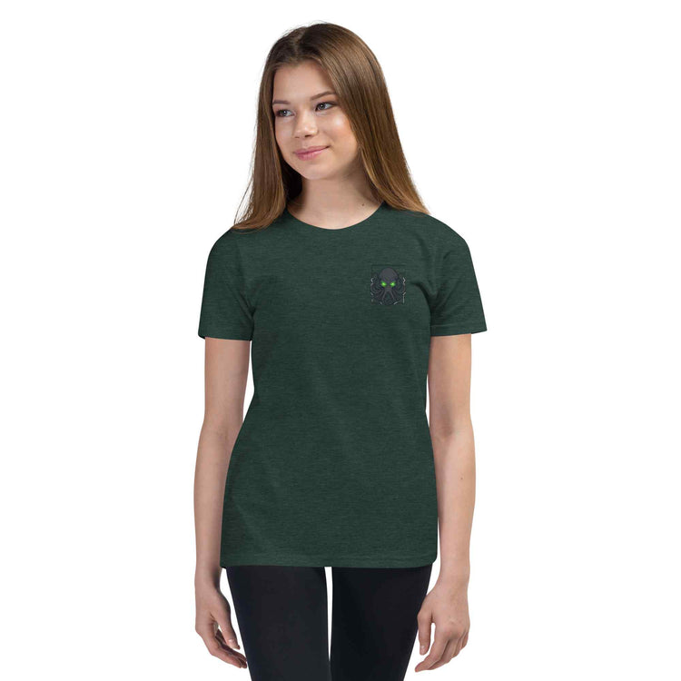 Person wearing a dark green t-shirt with a small  kraken logo on a white background