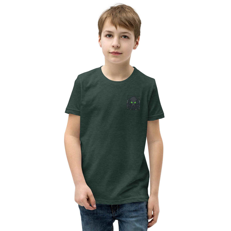 Child wearing a green t-shirt with a Kraken  logo on a white background