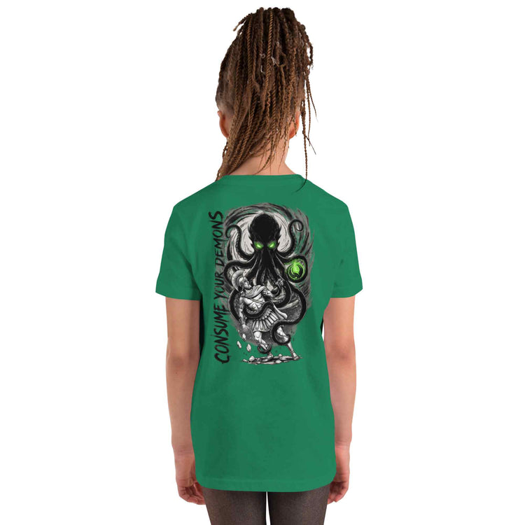 A child model shown from the back wearing a green t-shirt with a large black and white octopus graphic and the text 'CONSUME YOUR DEMONS' printed on the back.