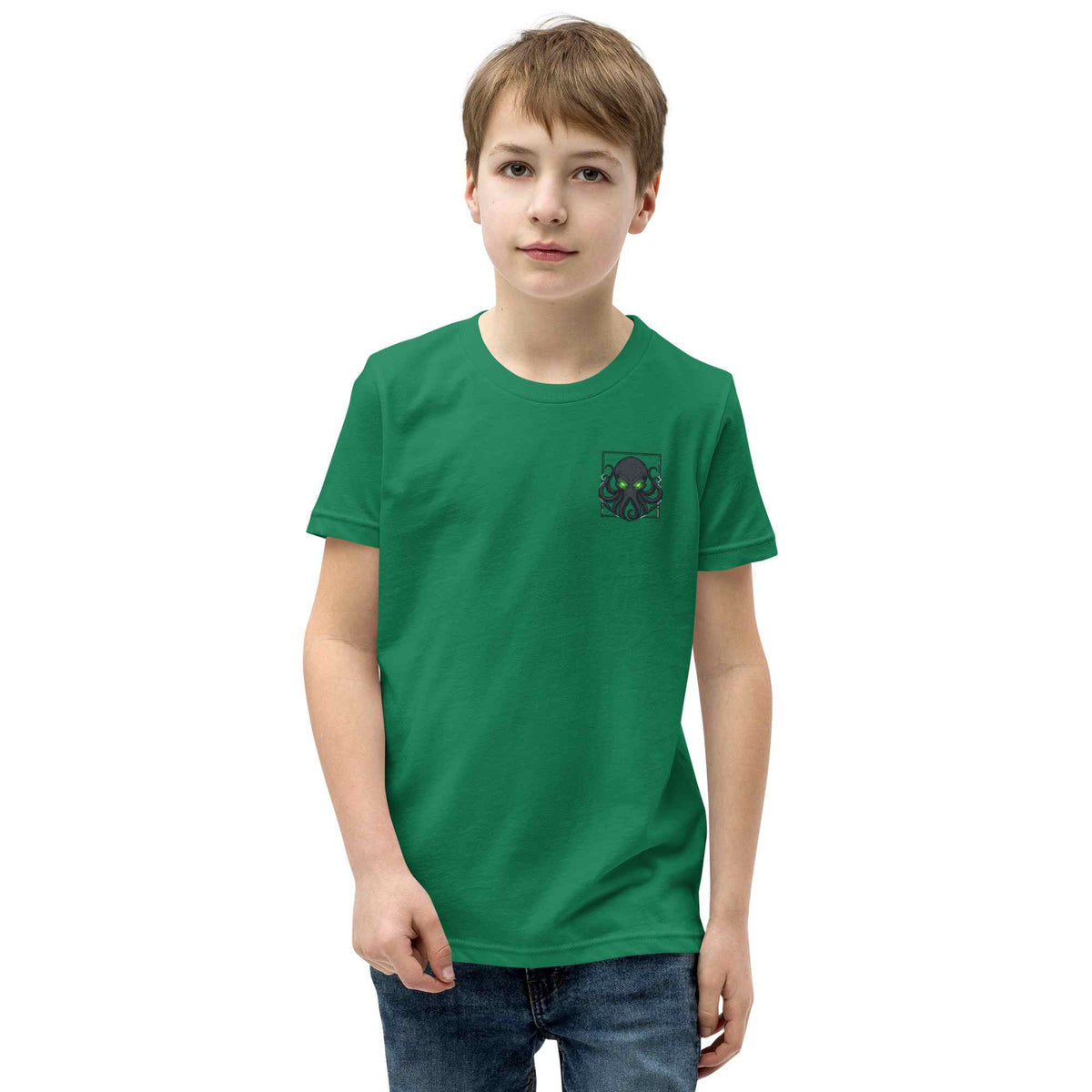 Young person wearing a green t-shirt with a  kraken on a white background