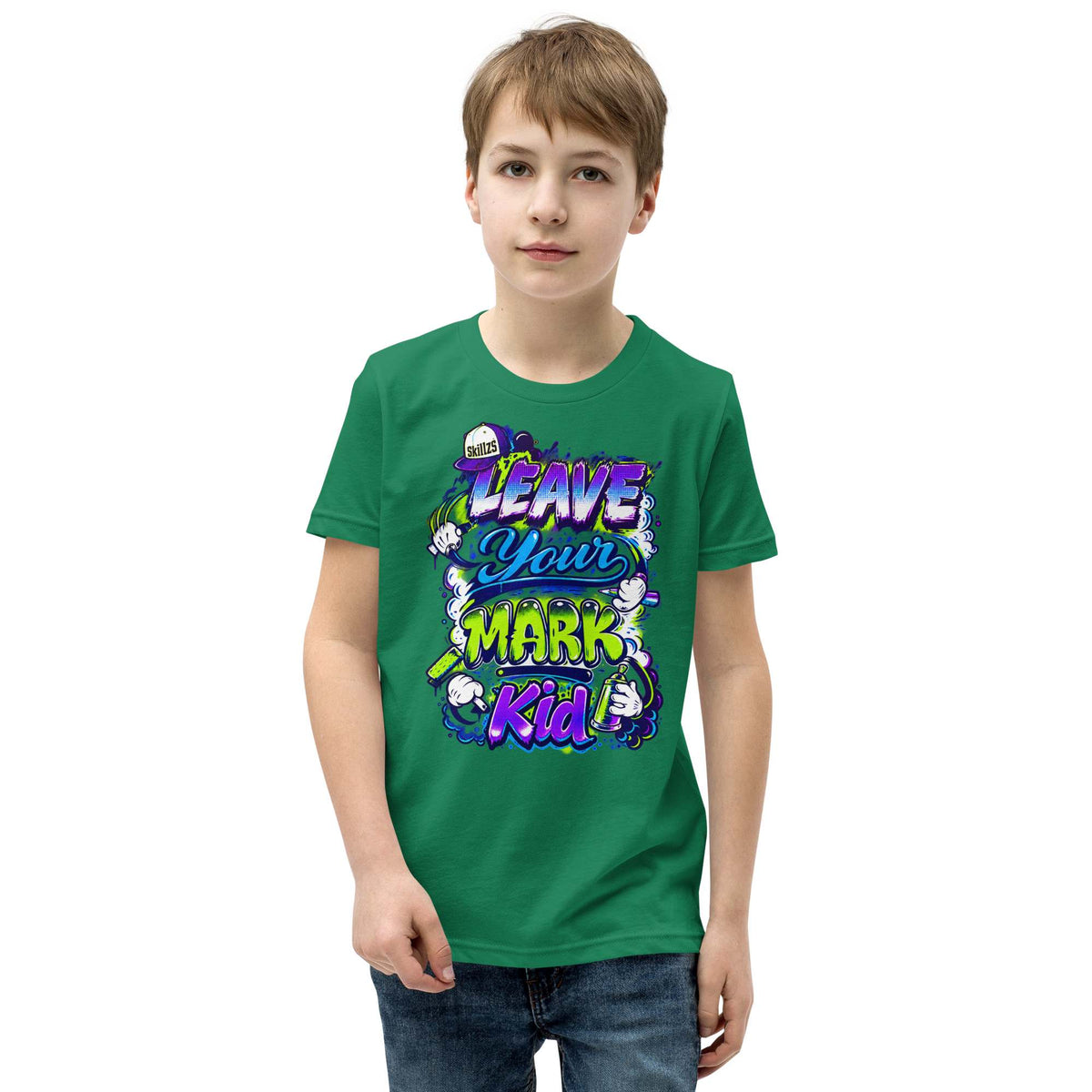 A young boy wearing a green crewneck t-shirt with a colorful graphic that reads 'LEAVE YOUR MARK Kid' in stylized purple, blue, and yellow lettering, set against a plain white background.