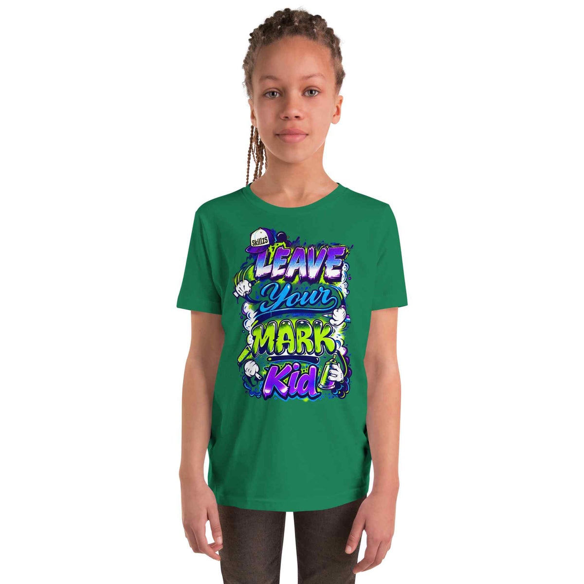 A child model wearing a green short-sleeve t-shirt with a colorful graphic print that reads 'LEAVE YOUR MARK KID' in stylized purple, blue, and yellow lettering, set against a plain white background.
