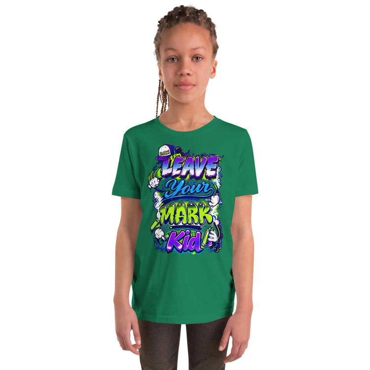 A child model wearing a green short-sleeve t-shirt with a colorful graphic print that reads 'LEAVE YOUR MARK KID' in stylized purple, blue, and yellow lettering, set against a plain white background.