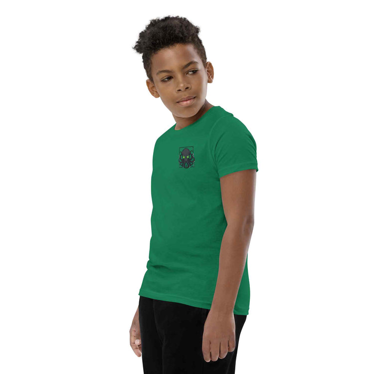 Child wearing a green t-shirt with a  kraken logo on a white background