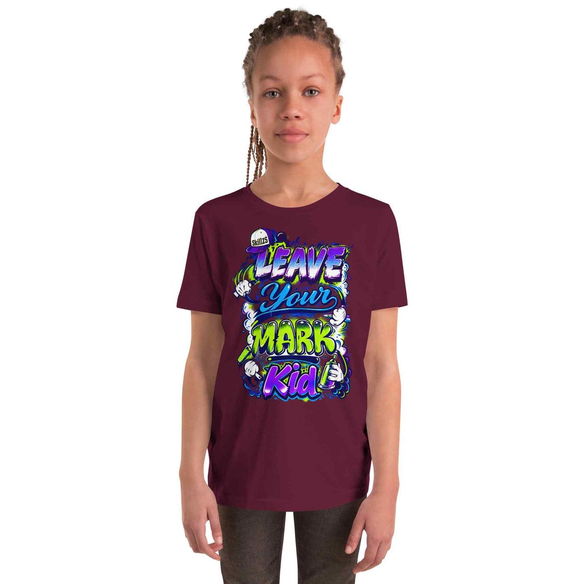 A child model wearing a maroon short-sleeve t-shirt with a colorful graphic that reads 'LEAVE YOUR MARK Kid' in stylized lettering, set against a plain white background.