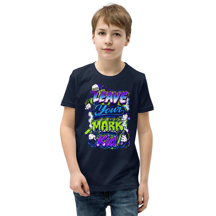 A young boy wearing a black graphic t-shirt with a colorful 'Leave Your Mark Kid' design, paired with blue jeans, set against a plain white background.
