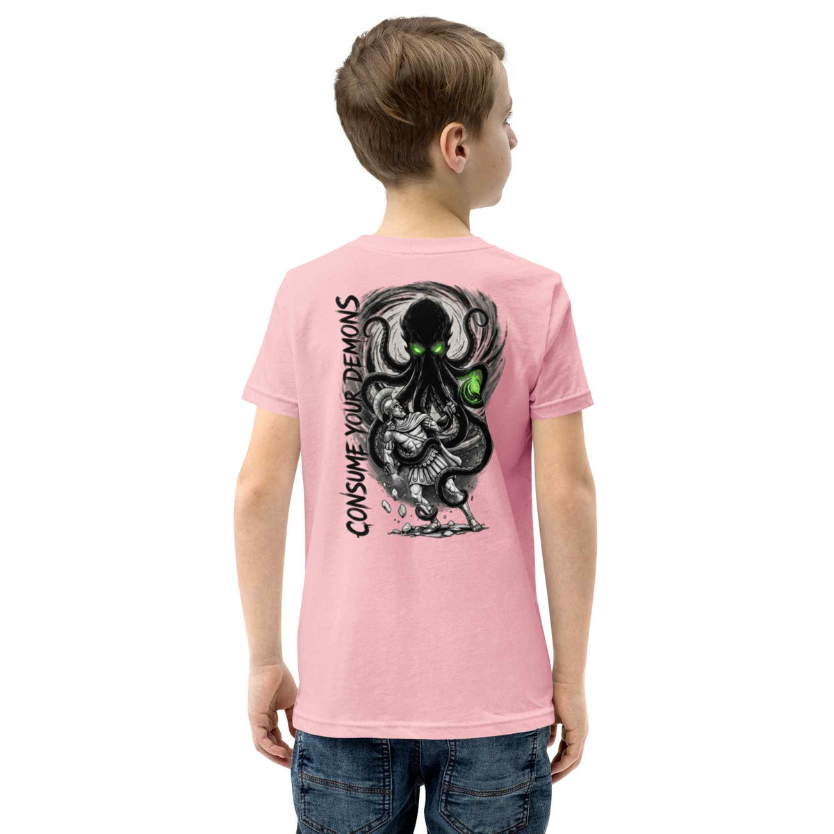 A child model from the back wearing a light pink t-shirt with a large black and gray octopus graphic and the text 'CONSUME YOUR DEMONS' printed on the back, paired with blue jeans against a plain white background.