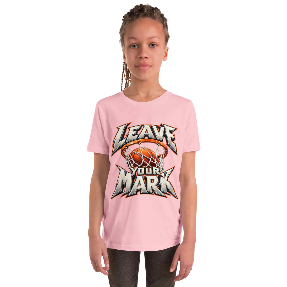 A young girl with braided hair wearing a light pink t-shirt with a 'LEAVE YOUR MARK' basketball graphic, standing against a plain white background.