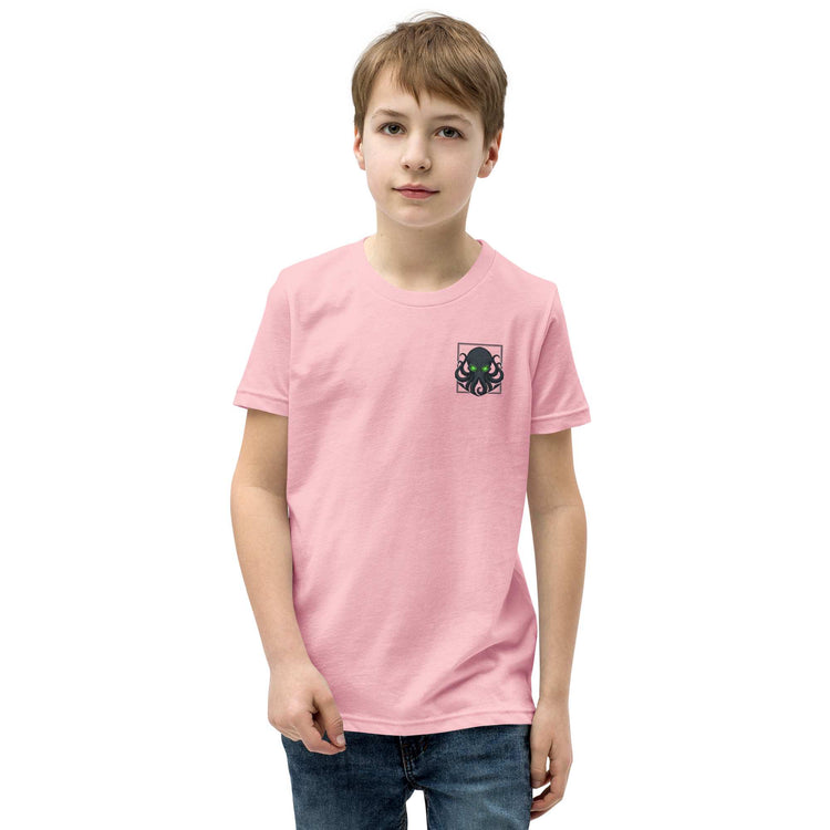 Child wearing a pink t-shirt with a small  kraken logo on a white background
