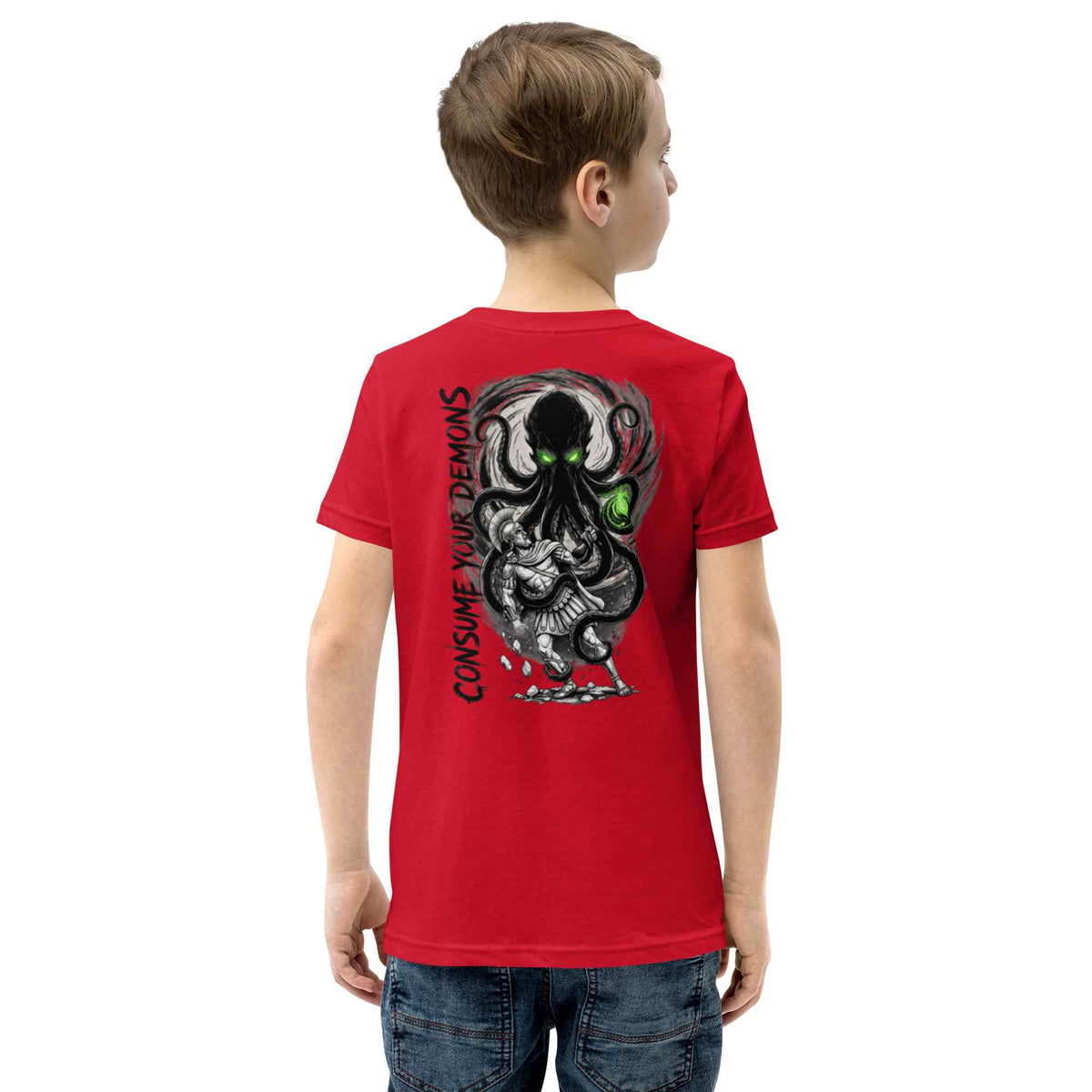 A child model shown from the back wearing a bright red t-shirt with a large black, gray, and green octopus graphic and the text 'CONSUME YOUR DEMONS' printed on the back, paired with blue jeans against a plain white background.