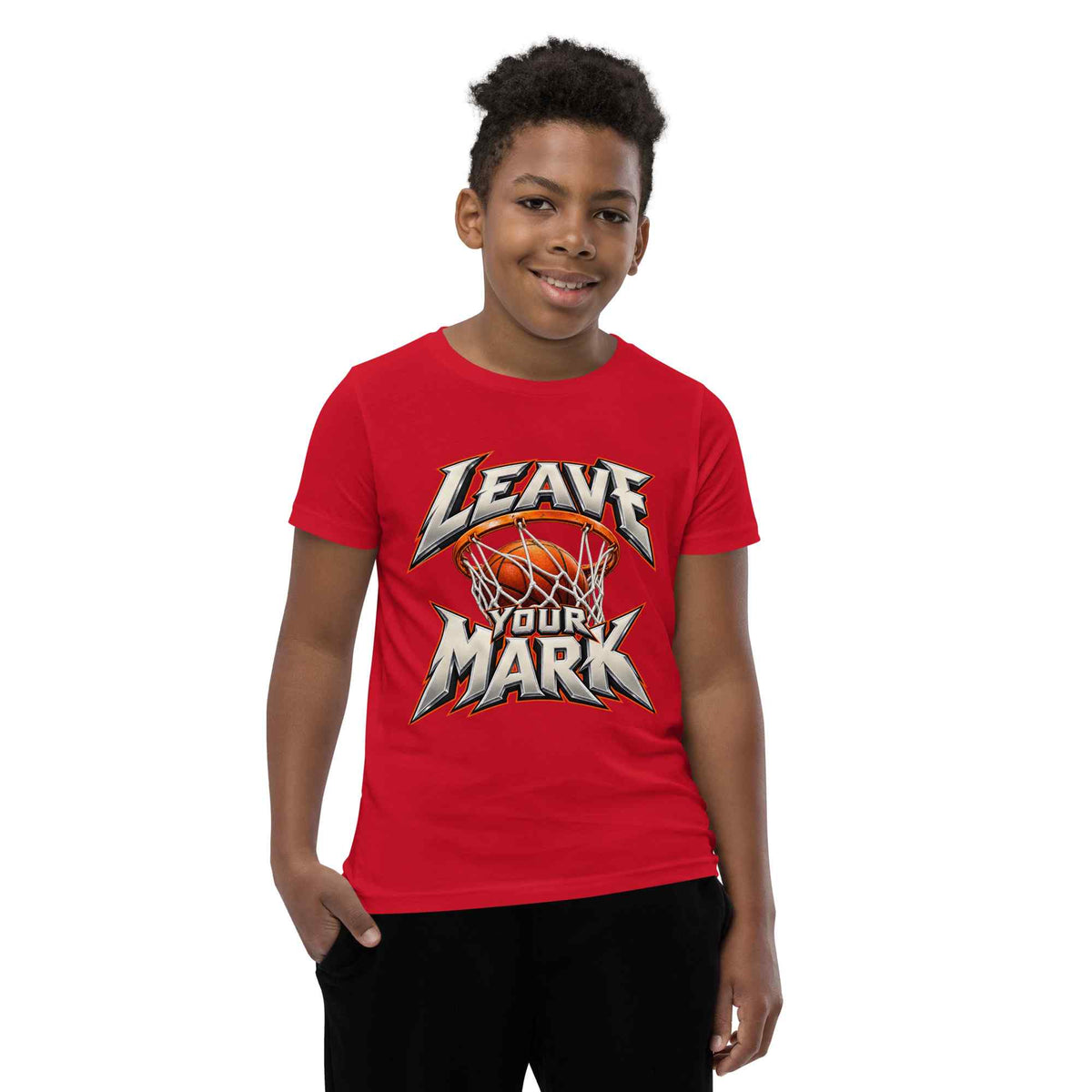 A young boy wearing a red short-sleeve t-shirt with a graphic that reads 'LEAVE YOUR MARK' in stylized white lettering around a basketball net, set against a plain white background