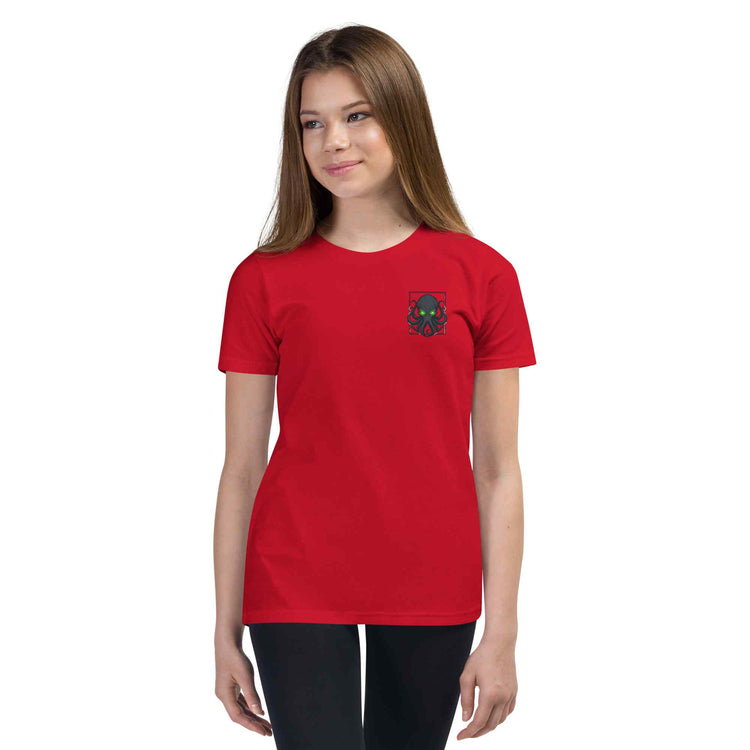 Person wearing a red t-shirt with a small  kraken logo on a white background