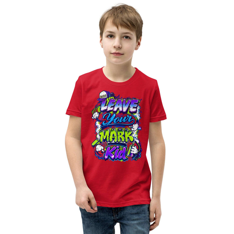 A young boy wearing a red crewneck t-shirt with a colorful graphic that reads 'LEAVE YOUR MARK Kid' in stylized bubble letters, set against a plain white background.