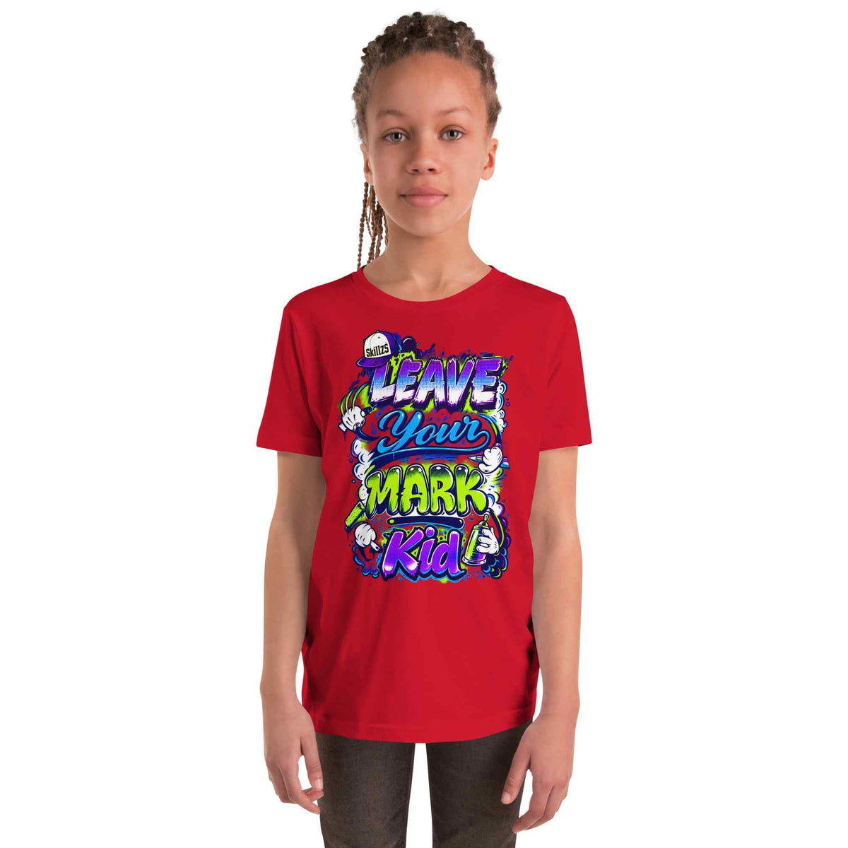 A young girl with braided hair wearing a bright red short-sleeve t-shirt with a colorful graphic that reads 'LEAVE YOUR MARK Kid' in stylized lettering, set against a plain white background.