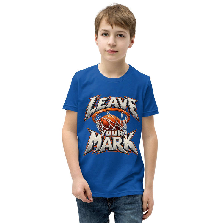 A young boy wearing a royal blue t-shirt with a 'LEAVE YOUR MARK' basketball graphic, standing against a plain white background.
