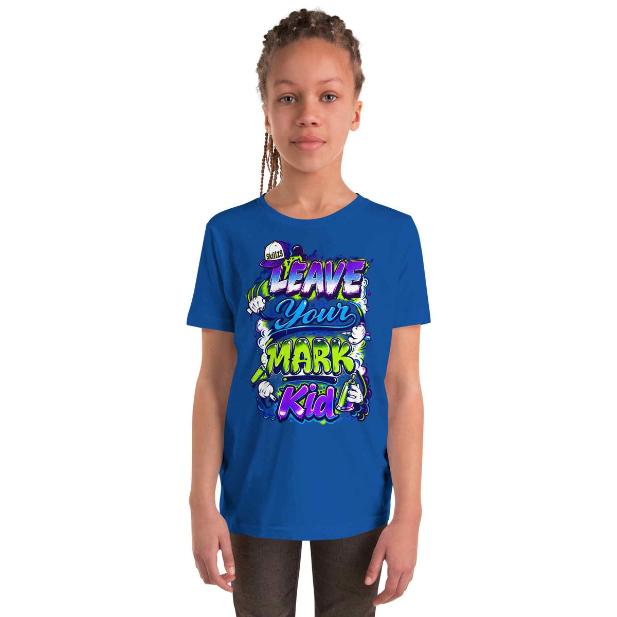 A young girl with braided hair stands against a plain white background wearing a royal blue t-shirt with a colorful graphic that reads 'LEAVE YOUR MARK KID'.