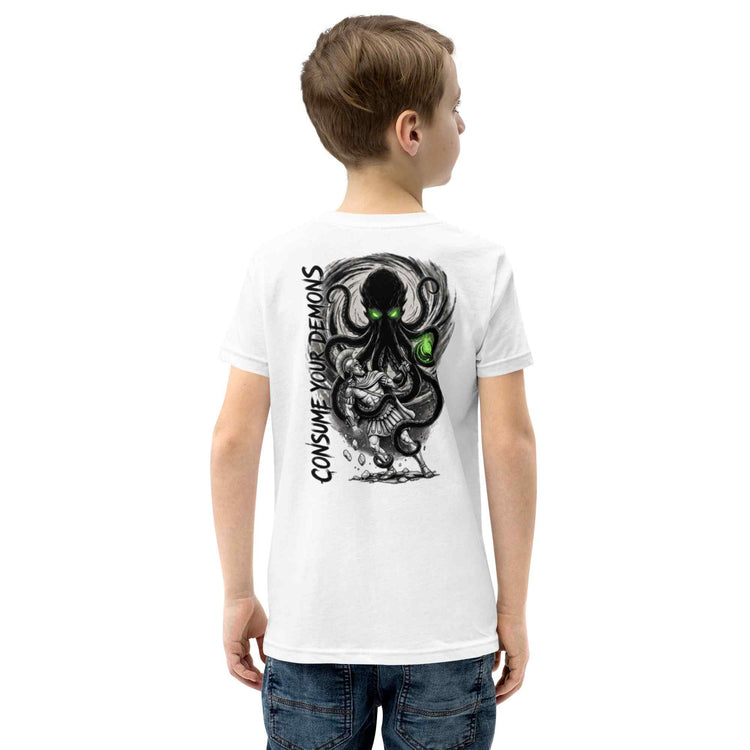 A child model shown from the back wearing a white short-sleeve t-shirt with a large black and gray octopus graphic and the text 'CONSUME YOUR DEMONS' printed on the back. The child is also wearing blue jeans against a plain white background.