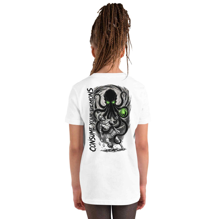 A child model shown from the back wearing a white short-sleeve t-shirt with a large black and gray octopus graphic featuring green eyes and the text 'CONSUME YOUR DEMONS' printed vertically on the back.